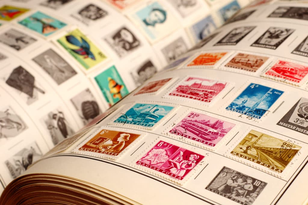 A person sorting stamps at a table